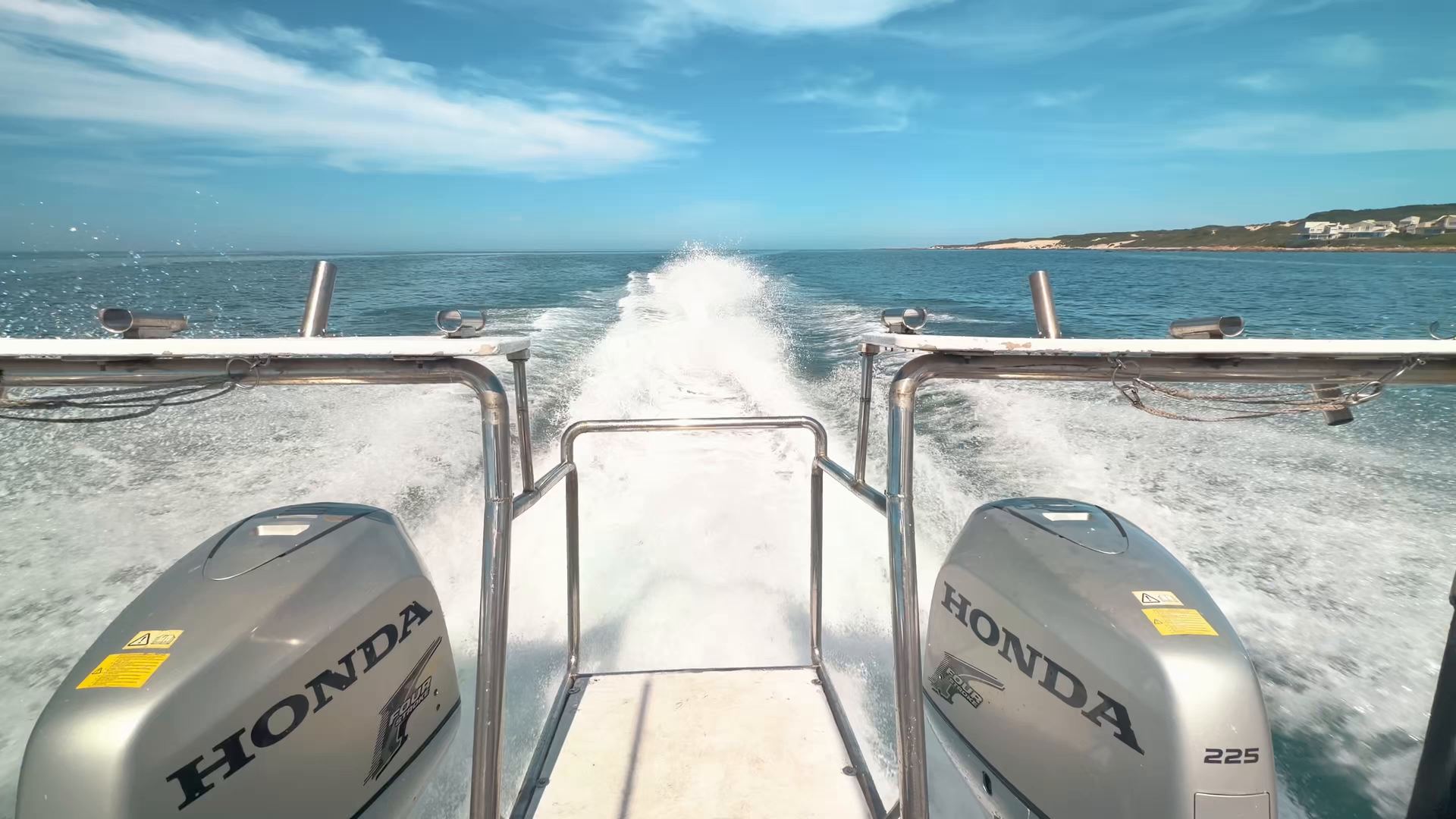 Looking back over the twin outboards of a St Francis Safaris boat as it speeds across the bay